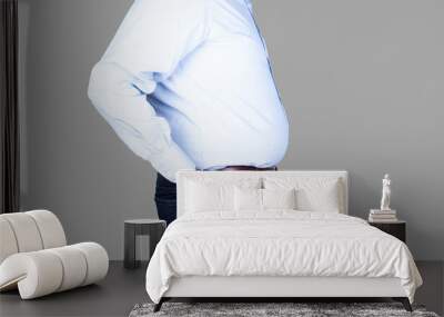 man with a big belly and overweight is wearing  a shirt and jeans Wall mural