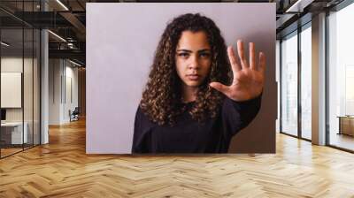 Confident black woman protesting against racial discrimination isolated on yellow background - Young diverse african woman showing black lives matter gesture - stop racism, human rights concept Wall mural