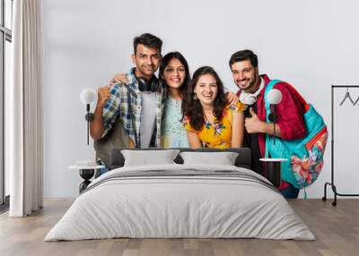 Asian Indian smart college students posing for a photo against white background Wall mural