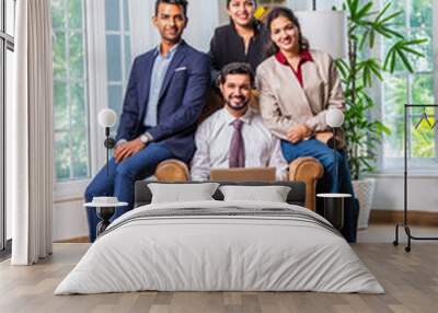 Group of young Indian asian business professionals using laptop in office Wall mural