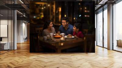 Happy indian family having dinner at home Wall mural