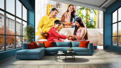 Indian family with kids celebrating rakhi or rakshabandhan festival or diwali Wall mural