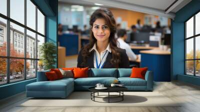 Indian happy bank employee looking at camera while standing in office Wall mural