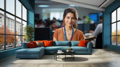 Indian happy bank employee looking at camera while standing in office Wall mural