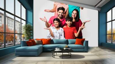 Indian Kids with parents / grandparents, sitting isolated over white background, studio shot Wall mural