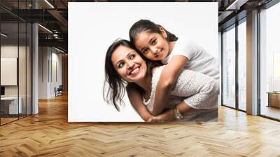 Indian mother daughter on white background hugging, kissing, riding, flying, pointing, presenting over white background Wall mural