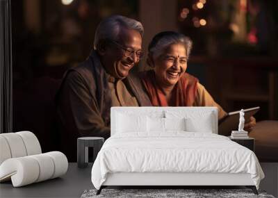 Indian senior couple having fun while using tablet computer or smartphone together Wall mural