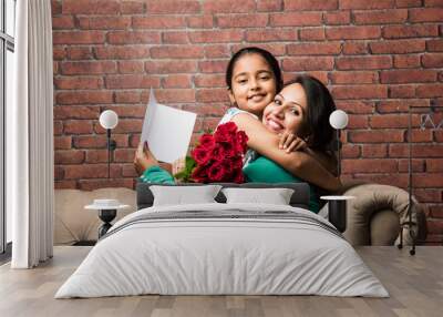 mother's day - indian girl / mother celebrating mother's day with rose flower bouquet, greeting card Wall mural