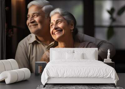 Portrait of Indian happy couple embracing each other at home on sofa or dining table Wall mural