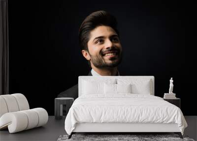 Portrait of Indian Male businessman standing over black background Wall mural