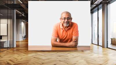 Portrait of senior or old Indian man at table Wall mural