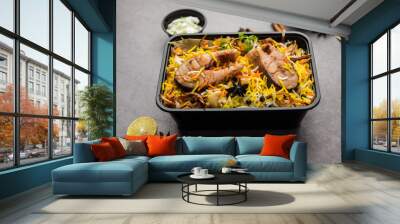 Restaurant style Fish Biryani or Pulao packed for home delivery in plastic box or container with Raita and salan Wall mural