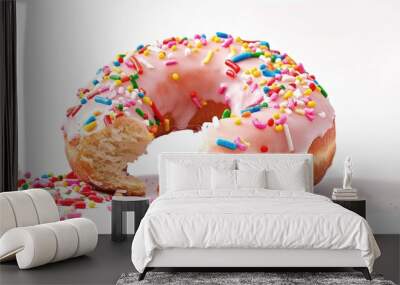 A large bite missing from a donut with glaze and sprinkles, set against a white background in a copy space image. Wall mural