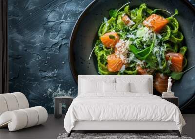 A plate of green pasta featuring salmon and cheese, set against a dark backdrop with copy space image. Wall mural