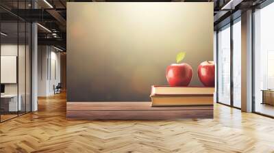 An apple is resting on top of a stack of books creating a copy space image that symbolizes the concept of education and going back to school Wall mural