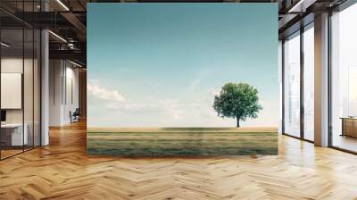 Lonely tree standing alone in an empty rural field with a vast expanse of beauty around it perfect for a copy space image Wall mural