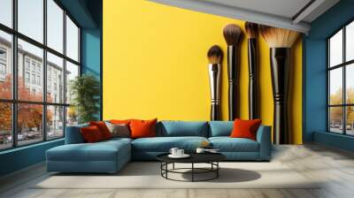 Makeup brushes arranged against a vibrant yellow backdrop with ample copy space image available Wall mural