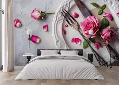 Mother's day concept with a plate featuring a fork and knife adorned with rose decorations, accompanied by a greeting card; perfect for gifting, copy space image. Wall mural