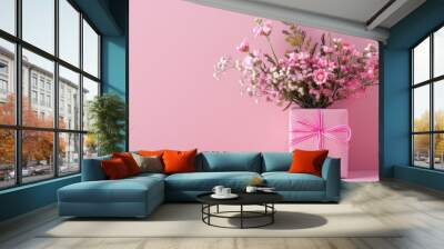 Present displayed with a bouquet in a pink gift box set against a pink background with copy space image. Wall mural