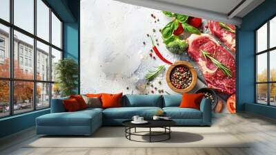 Top-down photo of raw beef steaks, fresh veggies, herbs, and spices arranged on a table with copy space image. Wall mural