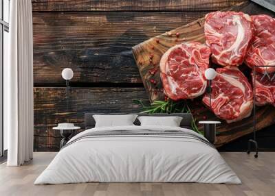 Top view of raw veal beef oxtail meat on a butcher wooden board with a cleaver, set against a dark wooden background, creating ample copy space image. Wall mural