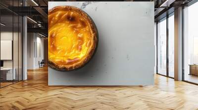 Traditional Portuguese egg custard tart known as pastel de nata displayed in a top view on a gray background with copy space image Wall mural