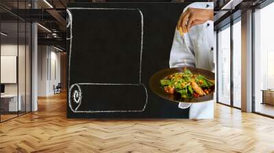 Chef holding health salad dish with chalk menu Wall mural