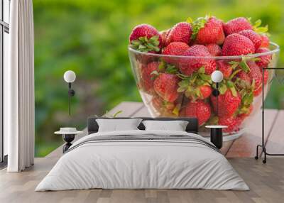 Glass bowl of strawberries on a wooden table Wall mural