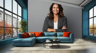 Portrait of a happy business woman with arms crossed over grey background Wall mural