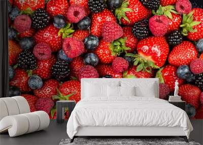 colorful tasty mix of wild forest berry fruits. Strawberry blueberry raspberry and blackberry. healthy eating nutrition vegan food concept background Wall mural