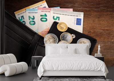 euro coin and bank note in black leather wallet on wood wooden business finance background  Wall mural