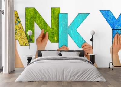 hands holding up the words thank you shaped by colorful wooden letters Wall mural