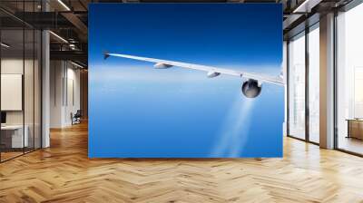 outside view on passenger airline airplane rear view with contrails from jet engine turbine blue wide cloud sky panorama background with copy space Wall mural