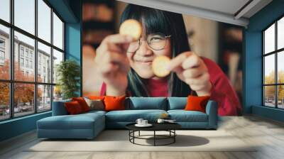 asian teenager show cream cracker at home dinning room Wall mural