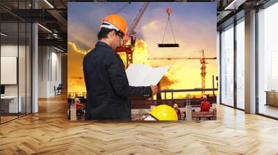 engineering man working in building construction site against be Wall mural