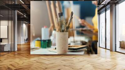 Creative woman painting on canvas in the studio Wall mural