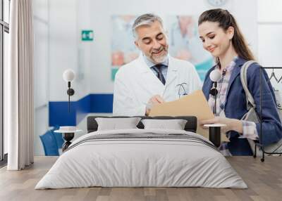 Doctor explaining medical records to his patient Wall mural