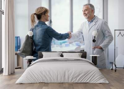 Doctor welcoming a patient in his office Wall mural