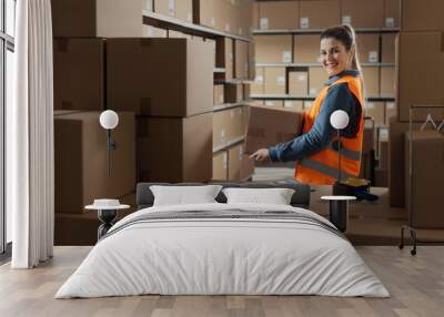 Portrait of a warehouse worker carrying a box Wall mural