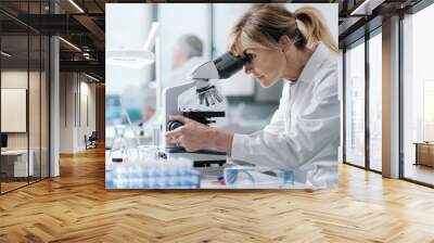 Professional scientist using a microscope Wall mural