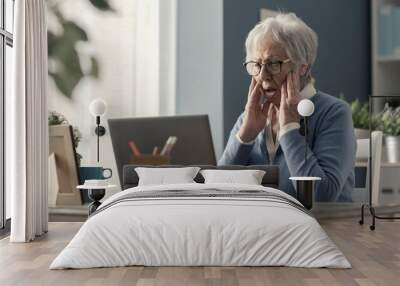 Senior woman struggling with technology Wall mural