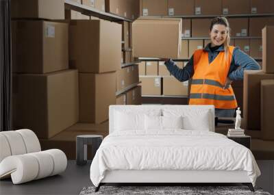 Strong warehouse worker lifting a box with one hand Wall mural