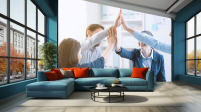 Successful young business team giving high five Wall mural