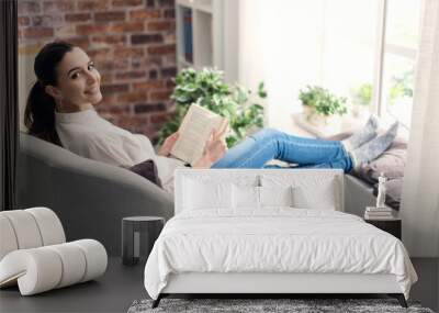 Woman relaxing and reading a book Wall mural