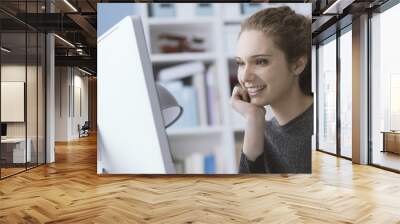 young woman using a computer in the office Wall mural