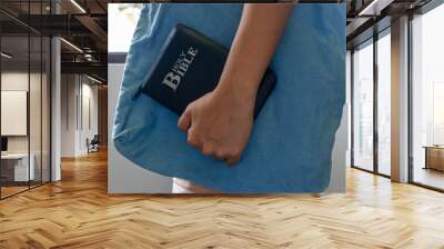 Asian female holding bible and bag  Wall mural