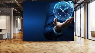 Businessman holding glowing holographic clock on dark blue background showcasing time management, modern technology, futuristic concept Wall mural