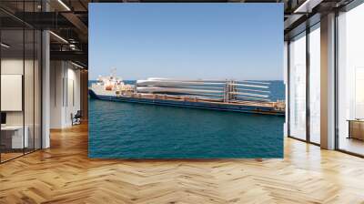 Heavy load carrier ship loaded with Electric Turbine Blades anchored at Sea, Aerial view Wall mural