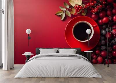 A bright red cup of black coffee encircled by fresh red fruits and leaves creating a vibrant and inviting scene. Wall mural