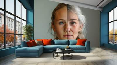 A conceptual image merging a young woman's face on one side with an older woman's face on the other, illustrating the concept of aging with copy space Wall mural